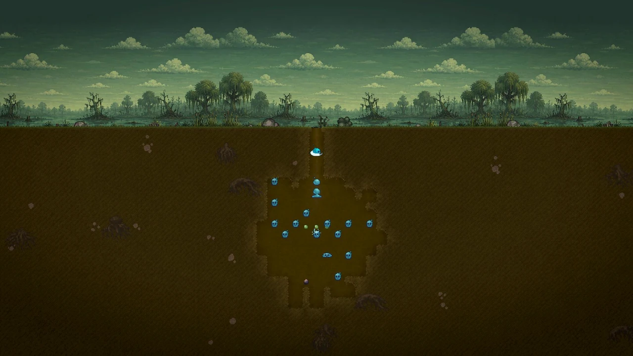 An underground slime nest with chambers beneath a green landscape.